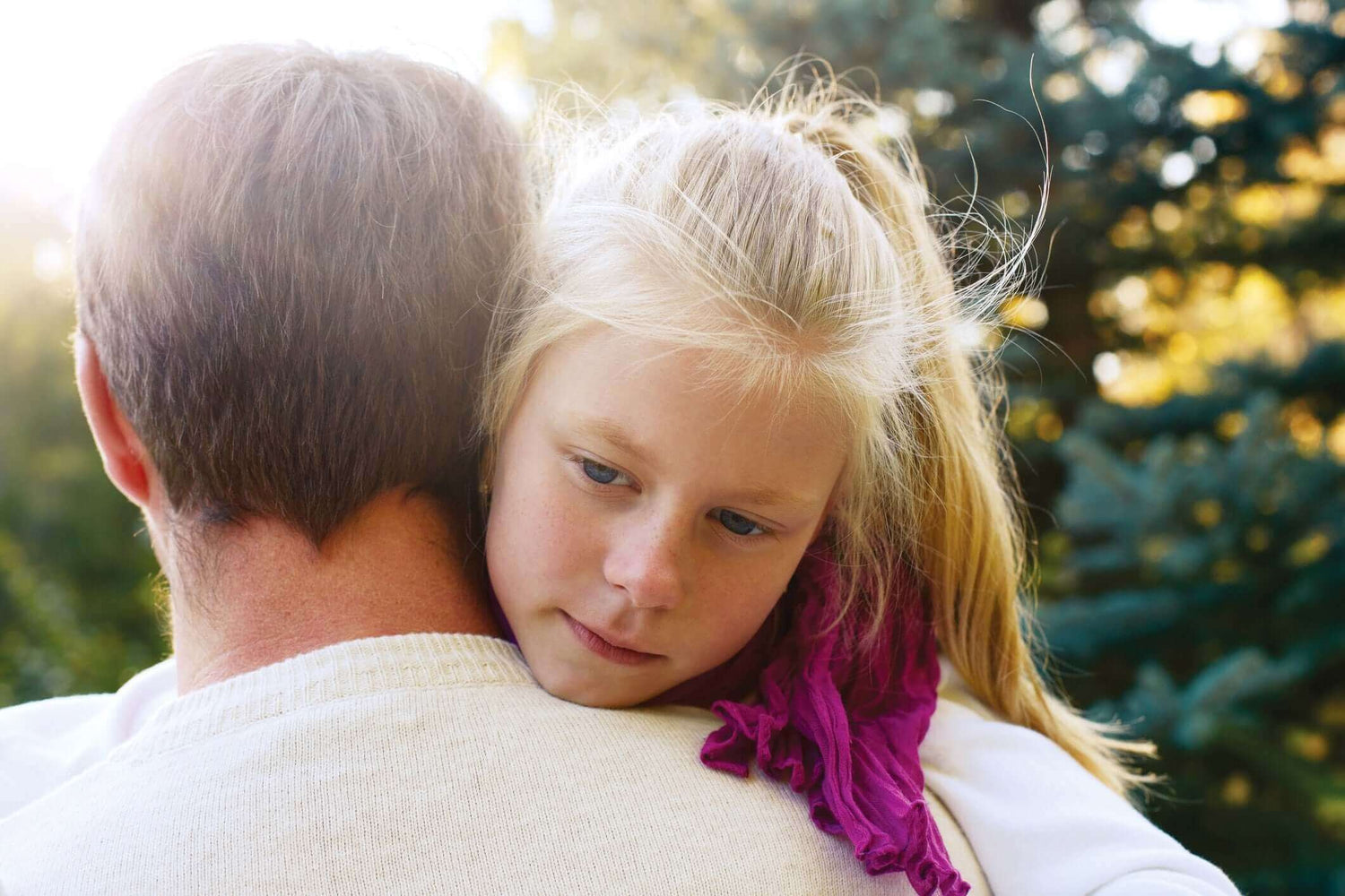 A baby hugging her father