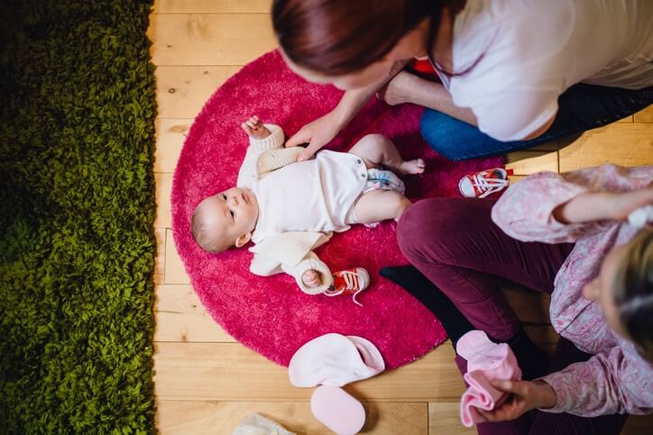 young mother plays with a baby