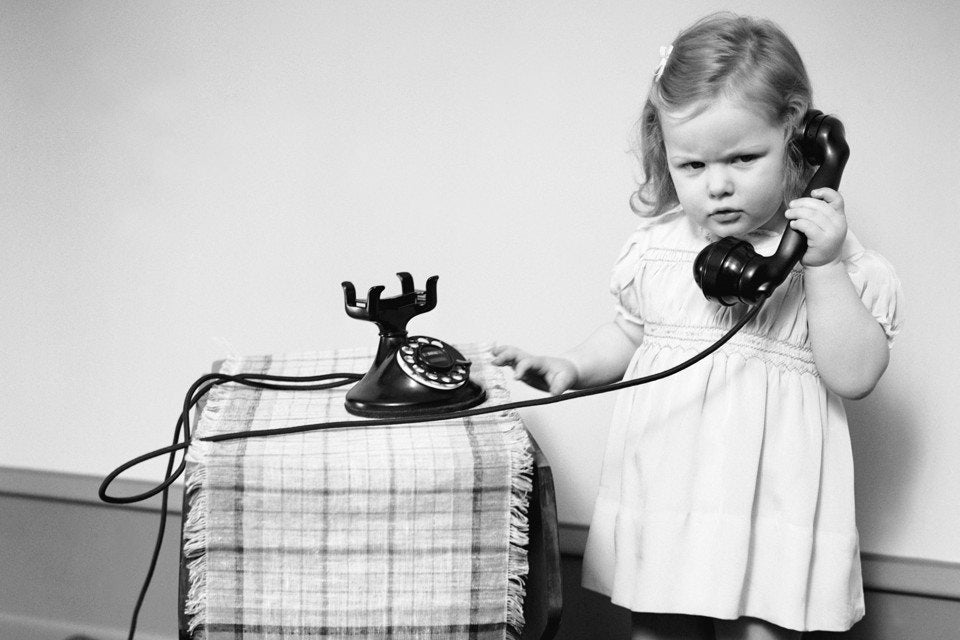 little girl taking on telephone
