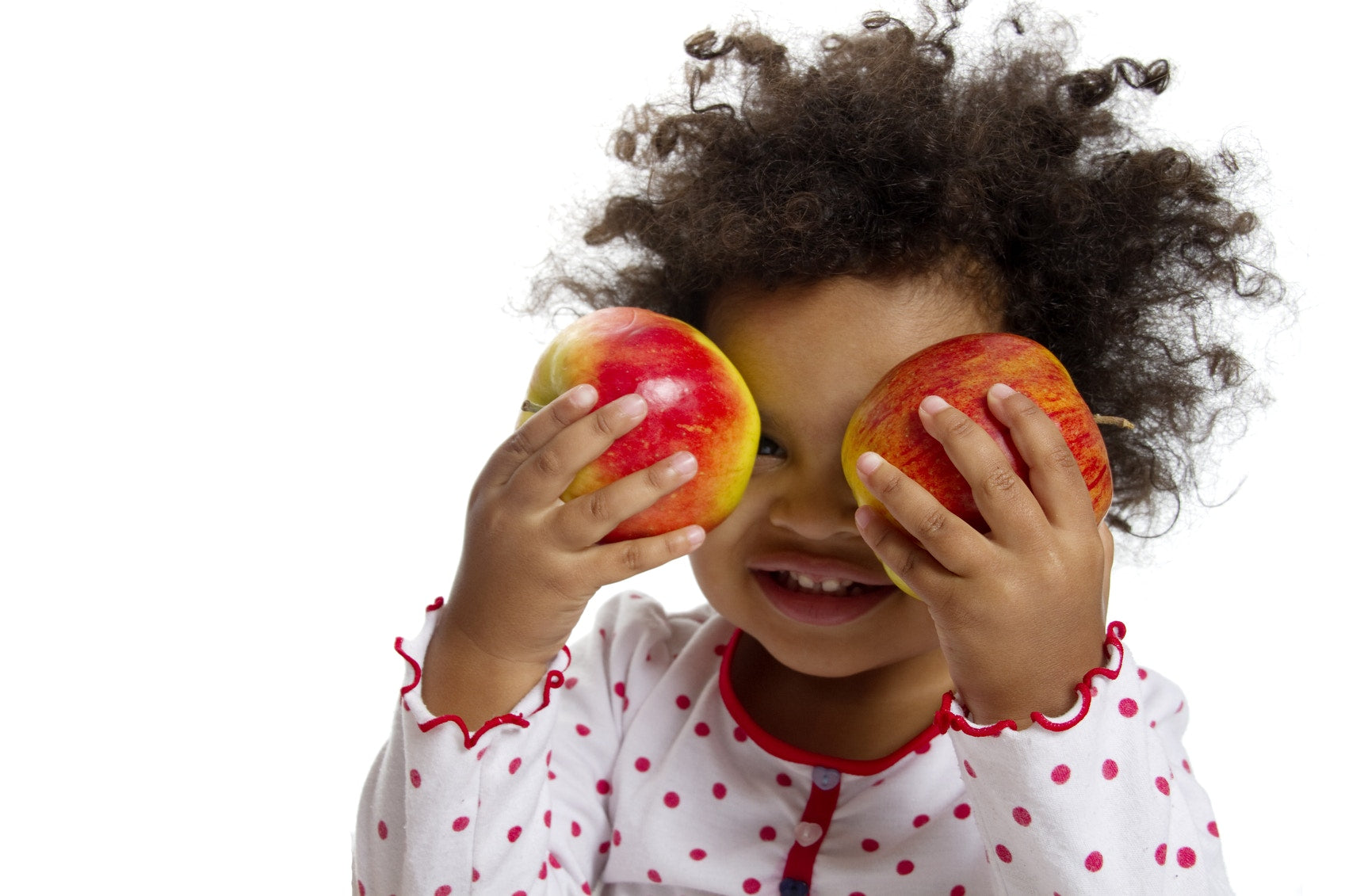 Toddler with two apples in his hand 