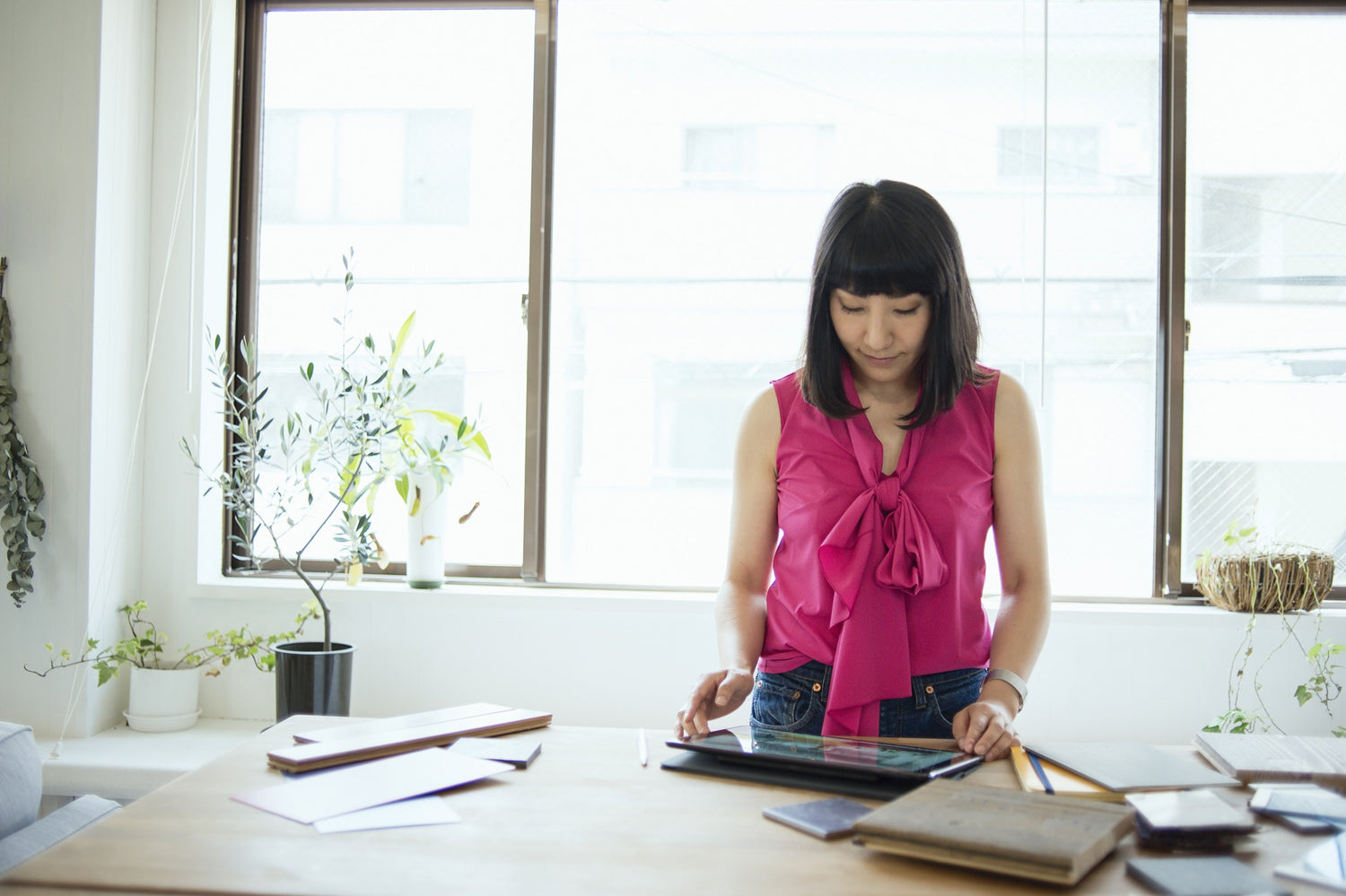 woman looking at ipad standing in office