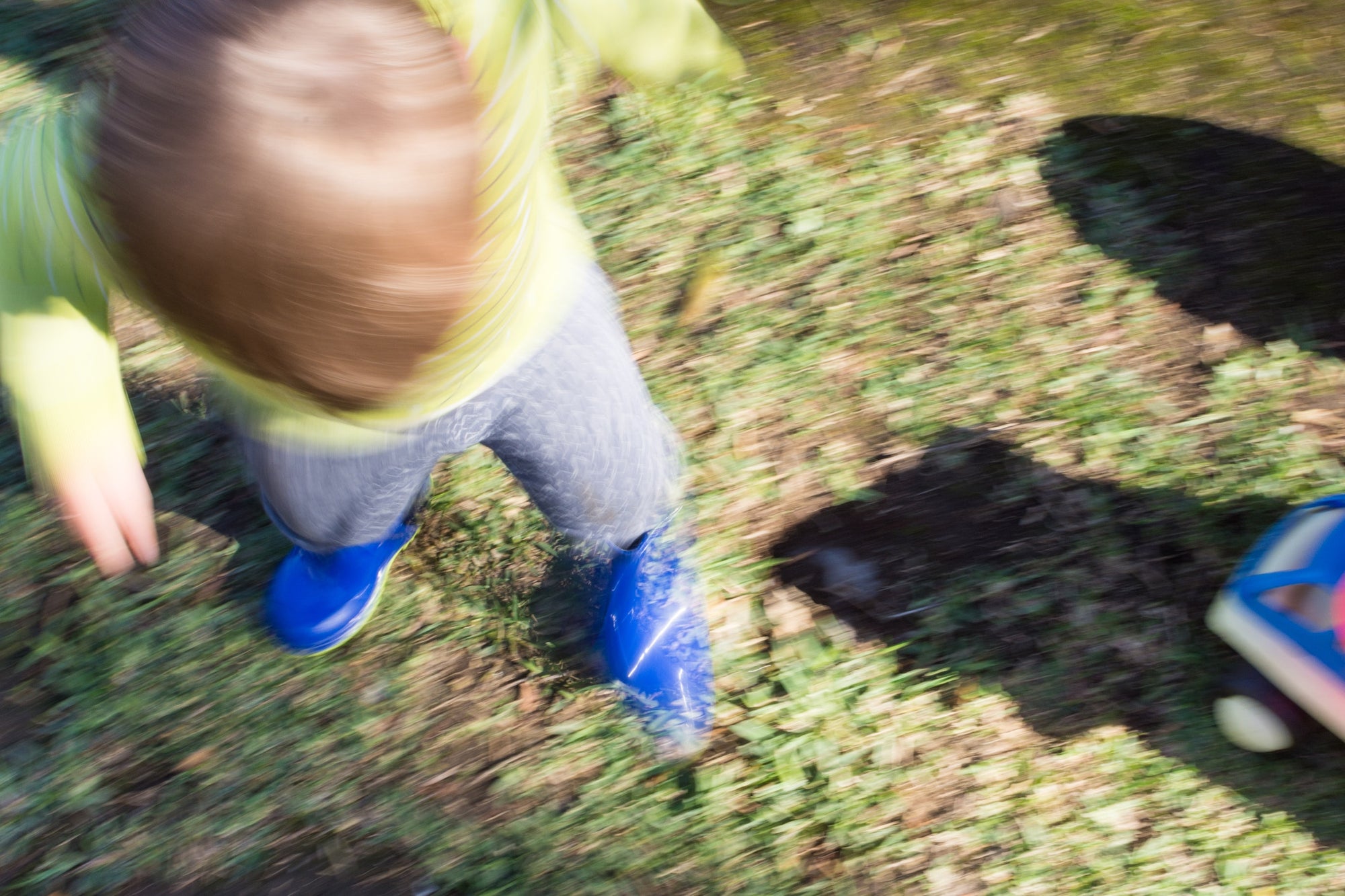 blur image of a kid playing in the garden