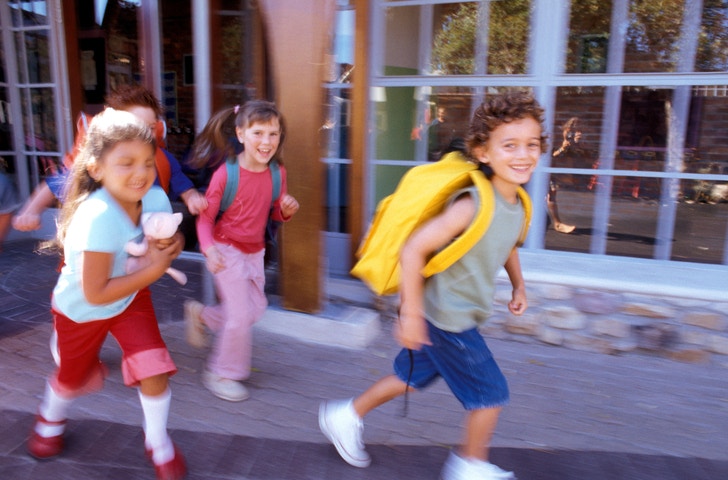  kids with backpack running 