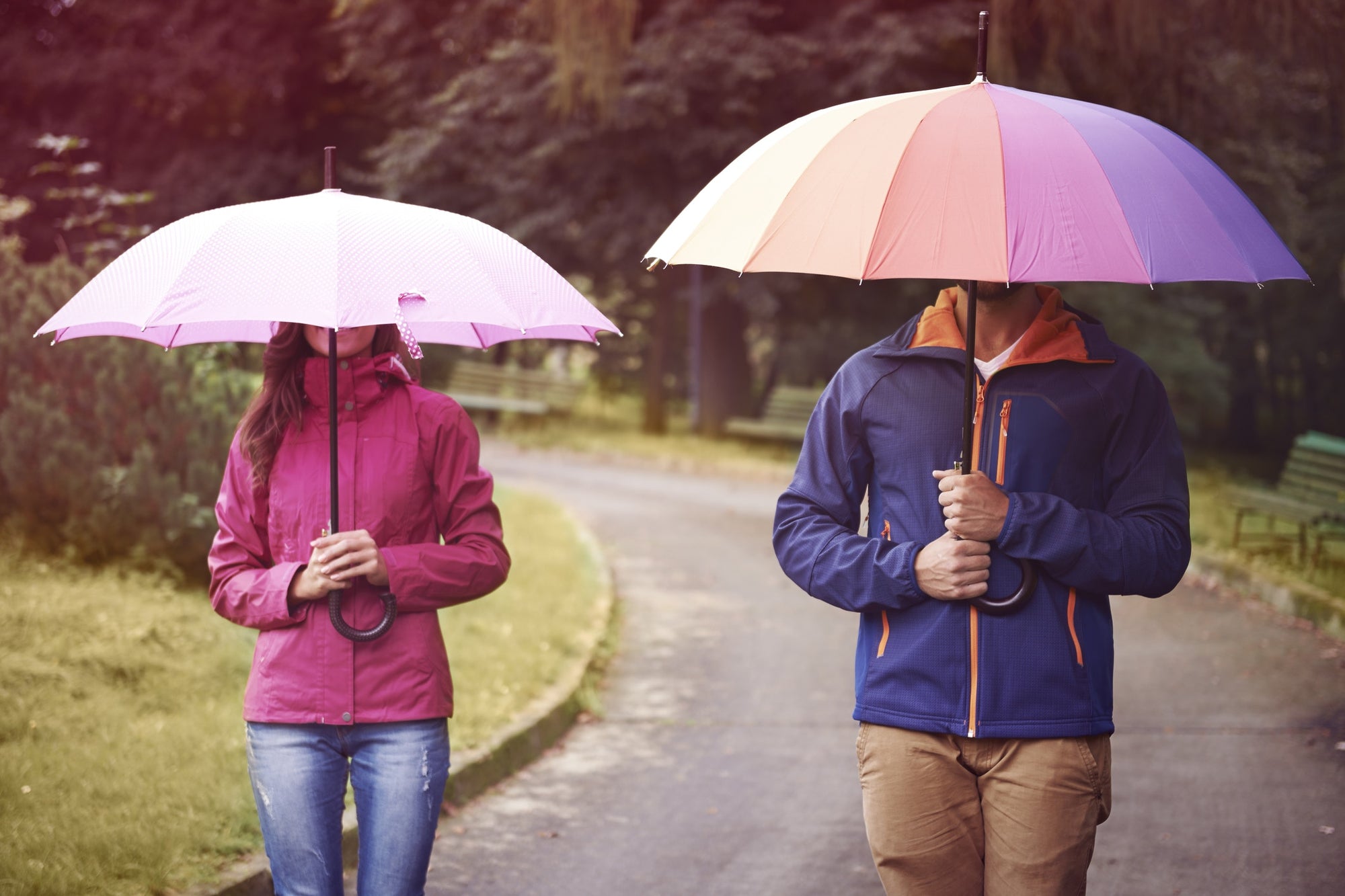 men and women covering face with an umbrella