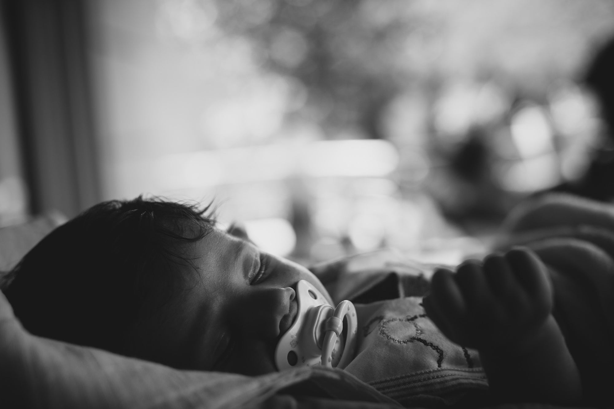 little newborn baby boy with pacifier sleeping
