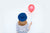 woman in hat holding balloon 