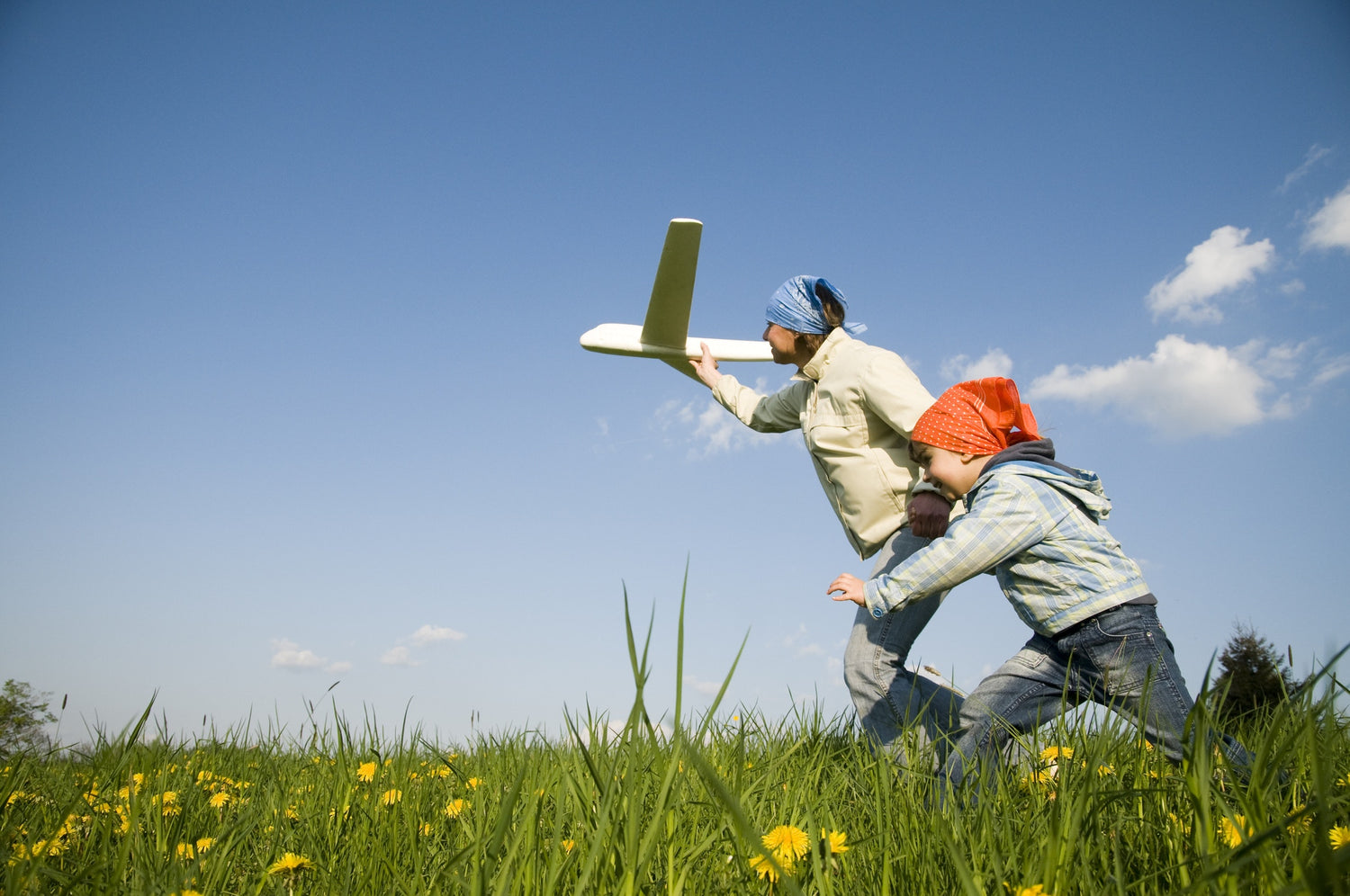 A child and his father palying with an aeroplane