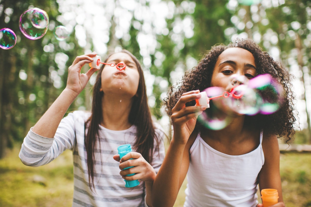 young girls playing with bubbles