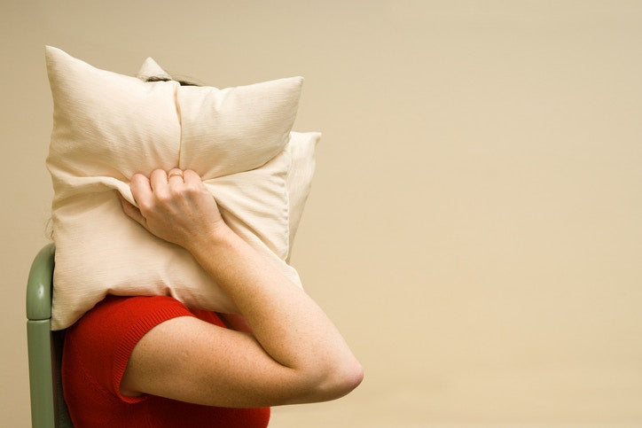 mom with pillows around her head not wanting to hear anything