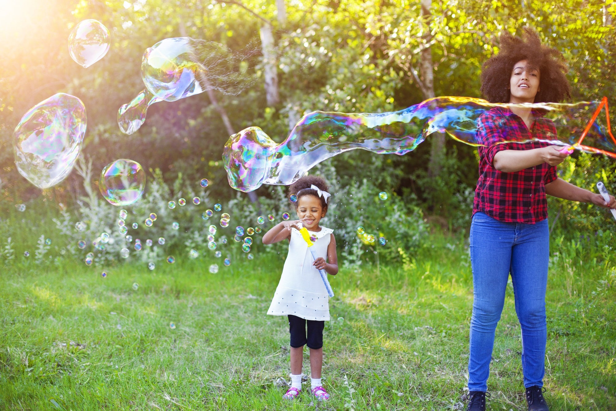 mother and daughter playing with bubbles