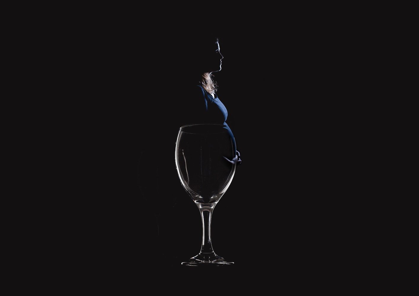 empty wine glass and a pregnant lady