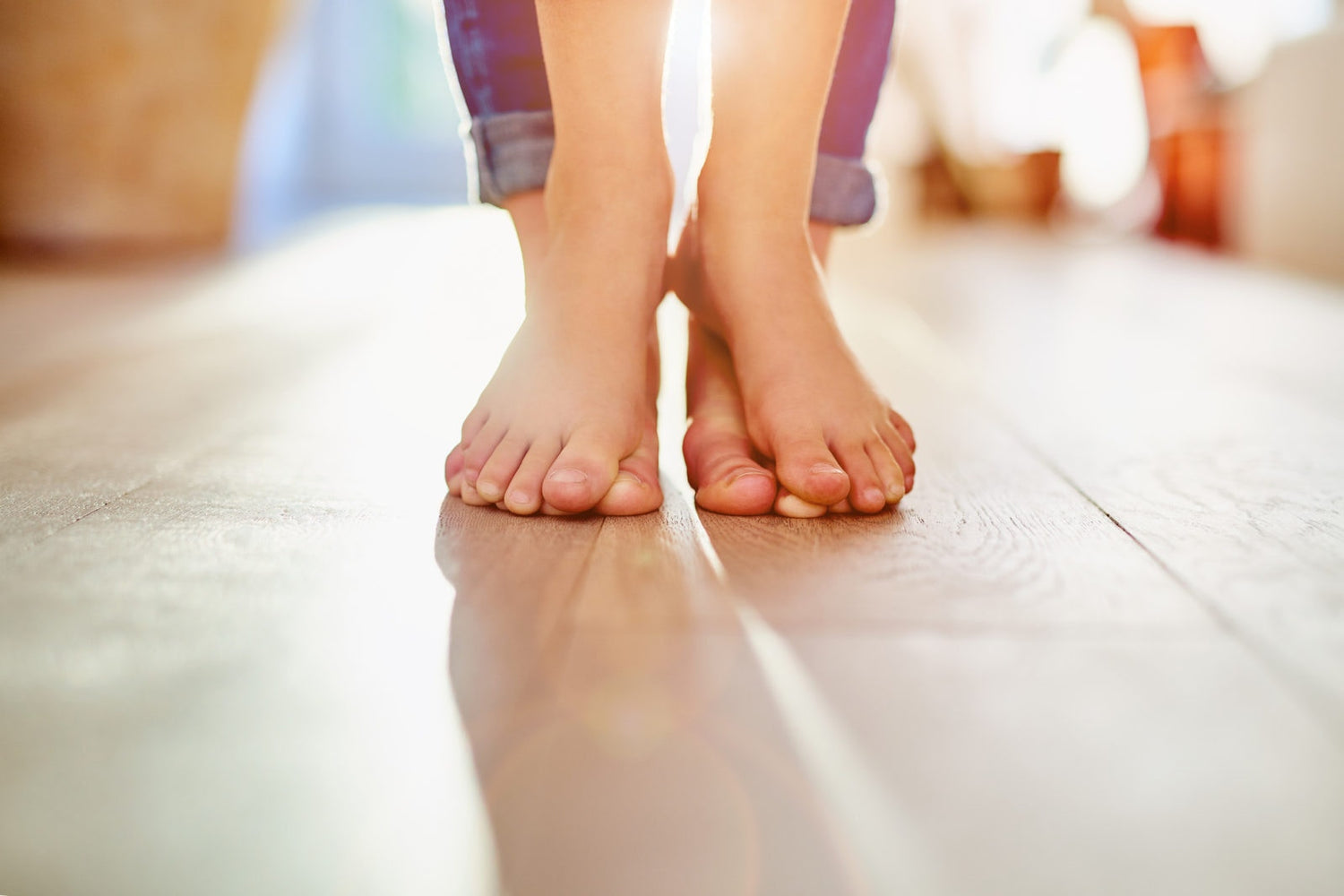 baby standing on mothers feet