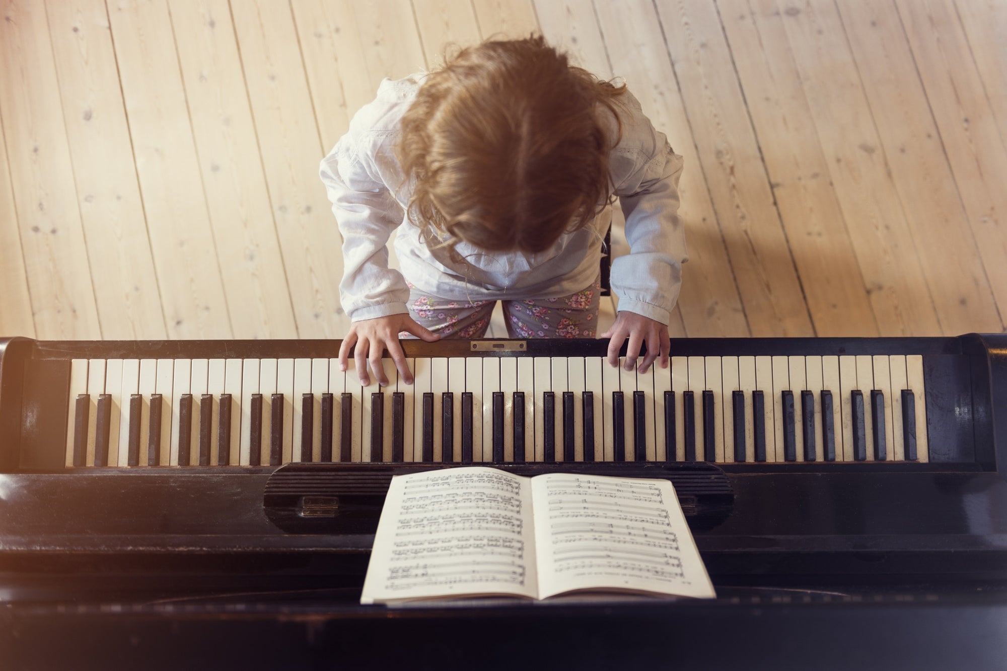 Young girl playing piano