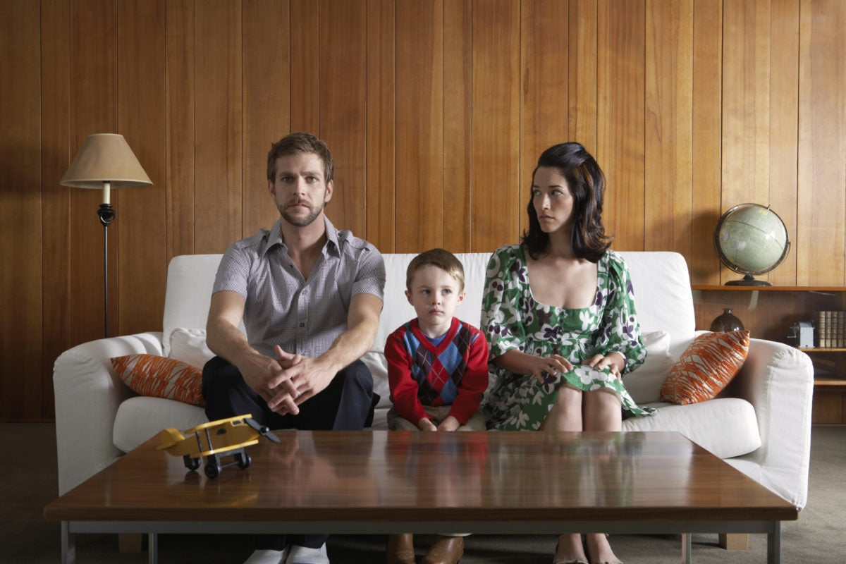 Family on a sofa mother staring to father