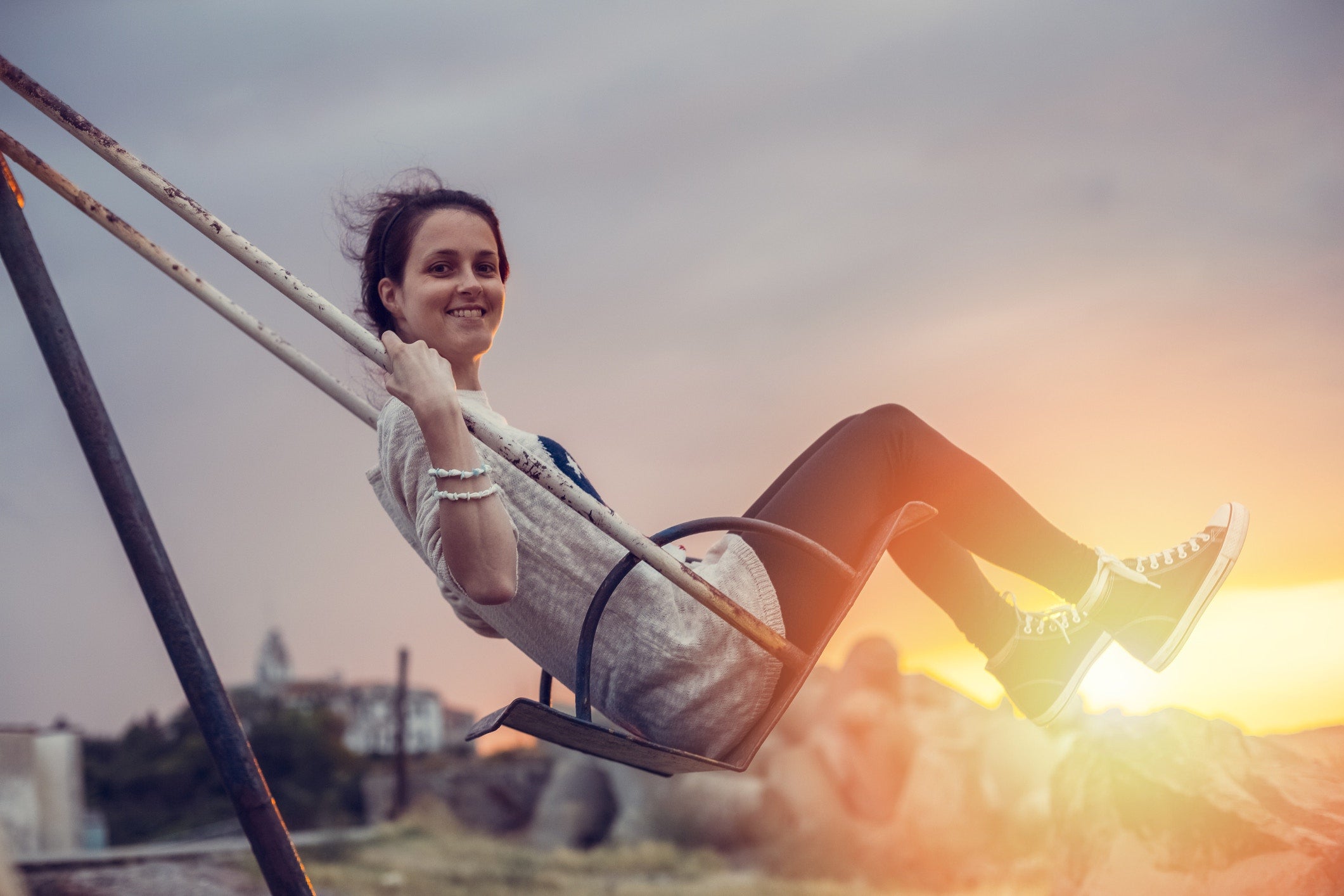 pretty girl swinging on a swing in a park