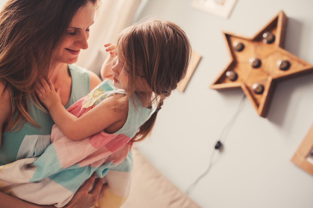 happy mother holding her daughter in her arms