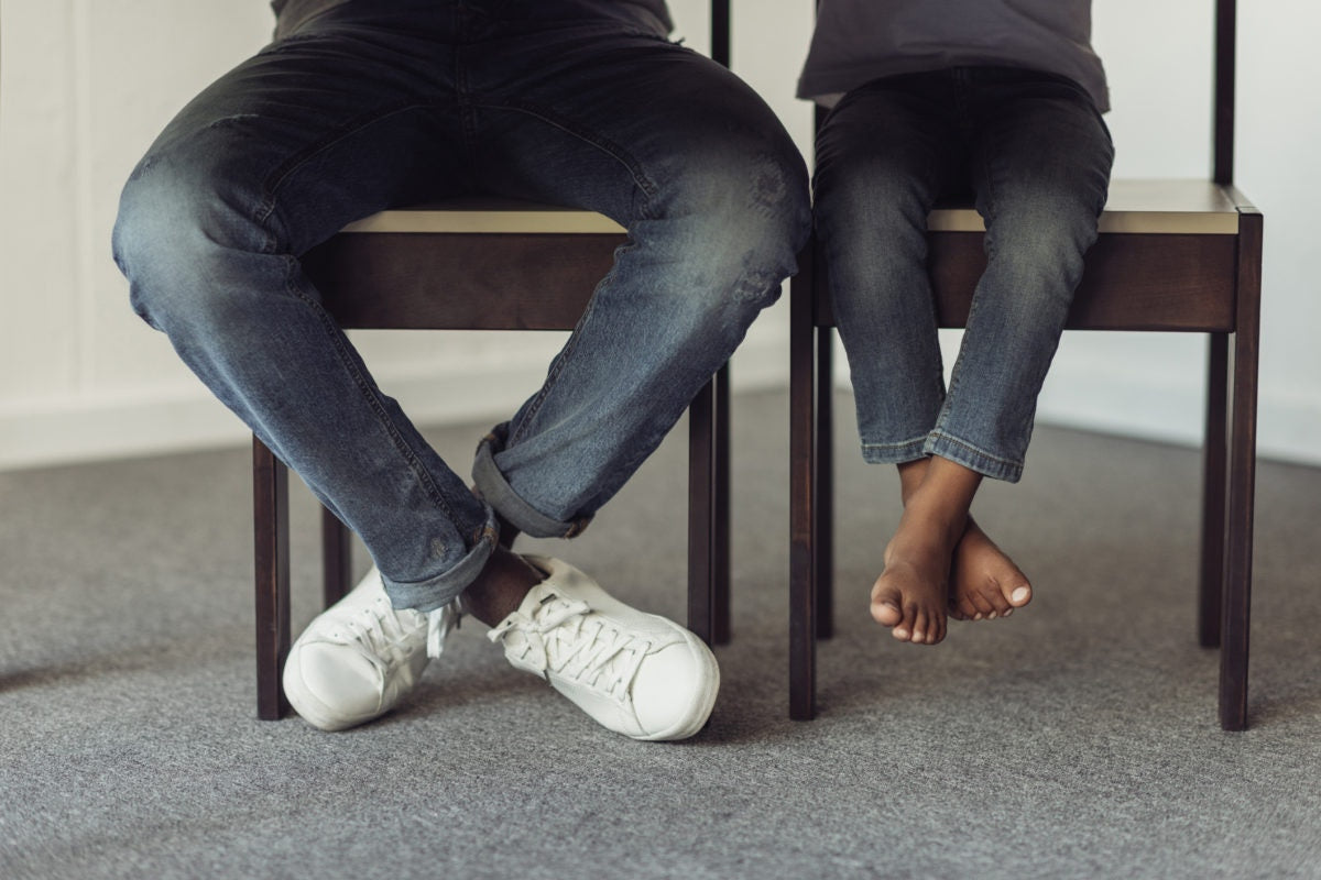 legs of father and son under table