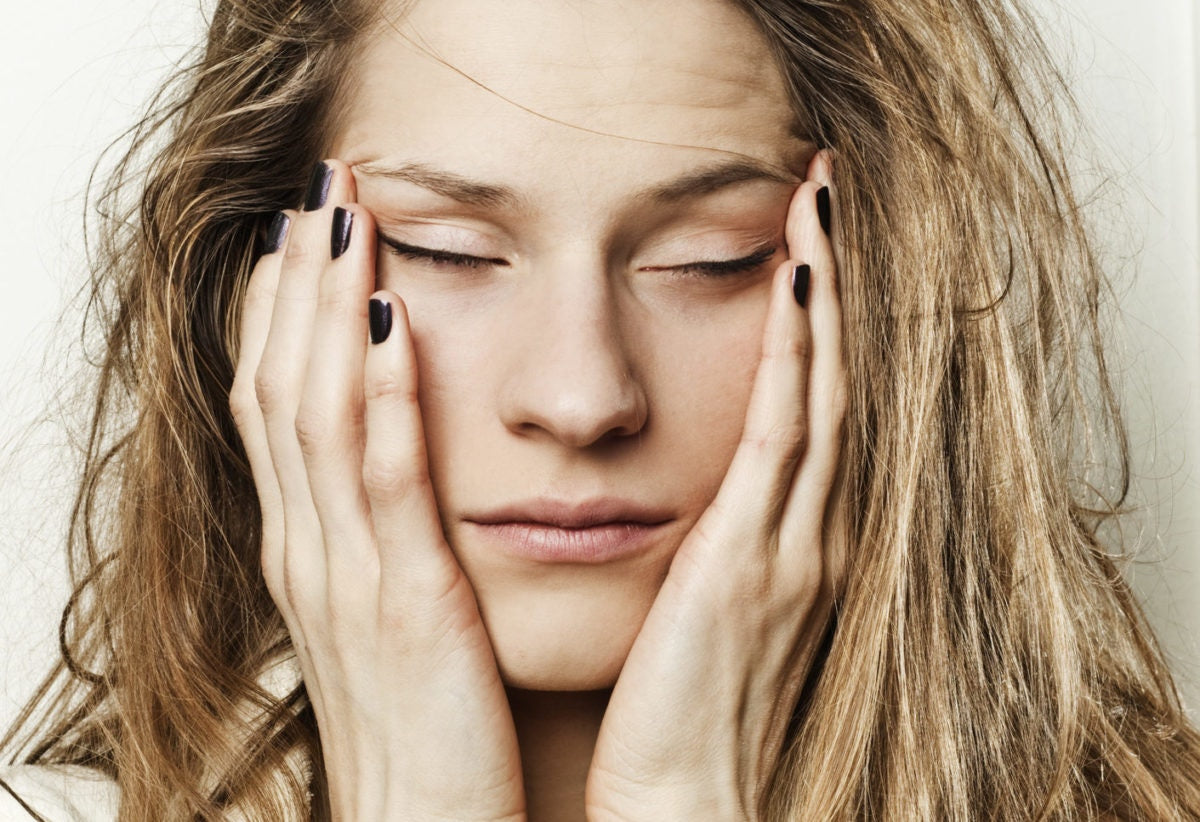 Girl holding her hands on her face