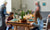 Two girls sitting in a dining hall with elder people blur image
