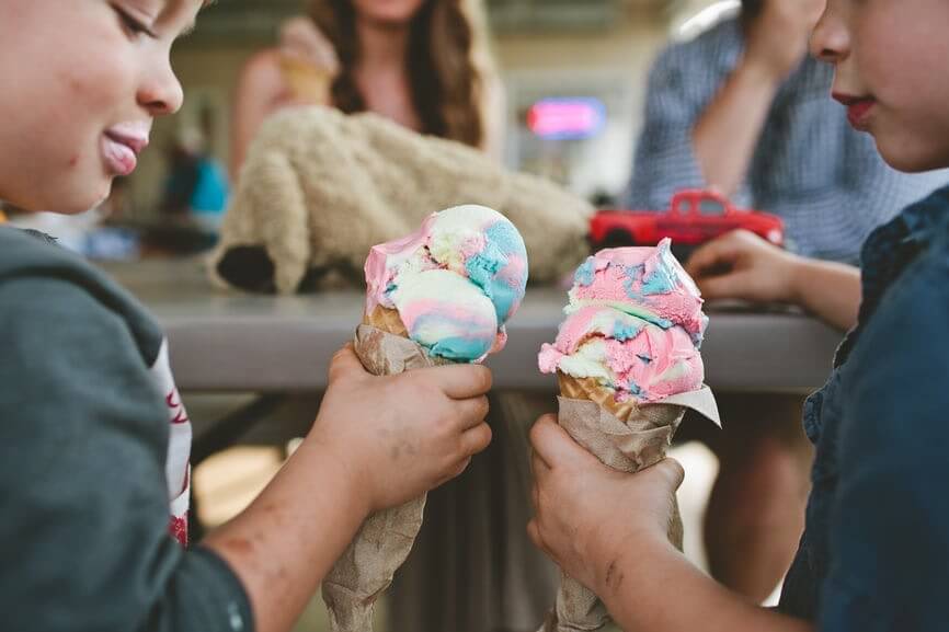 Happy young boys holding ice cream cone