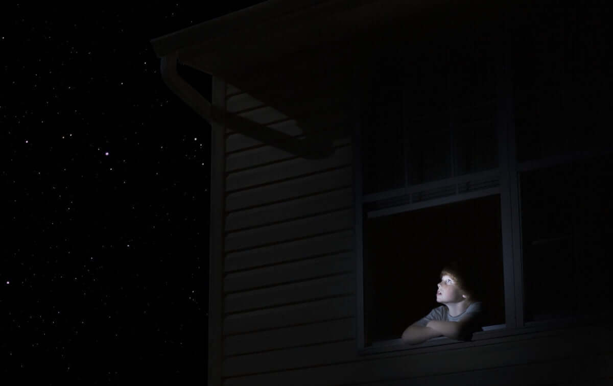 A boy is watching sky in a night time