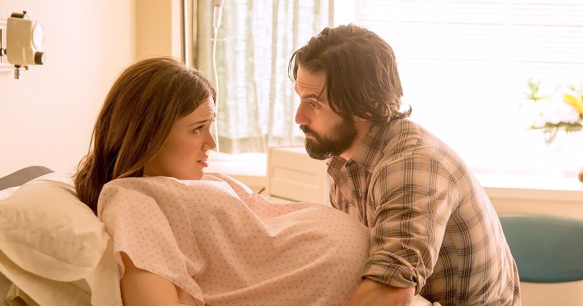 Supporting husband talking to his tensed pregnant wife in the hospital