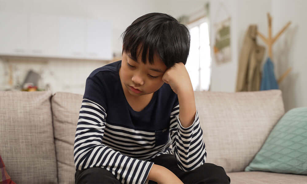 sad boy on a couch