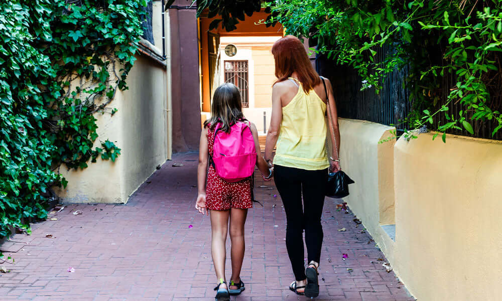 mother and daughter walking hand in hand