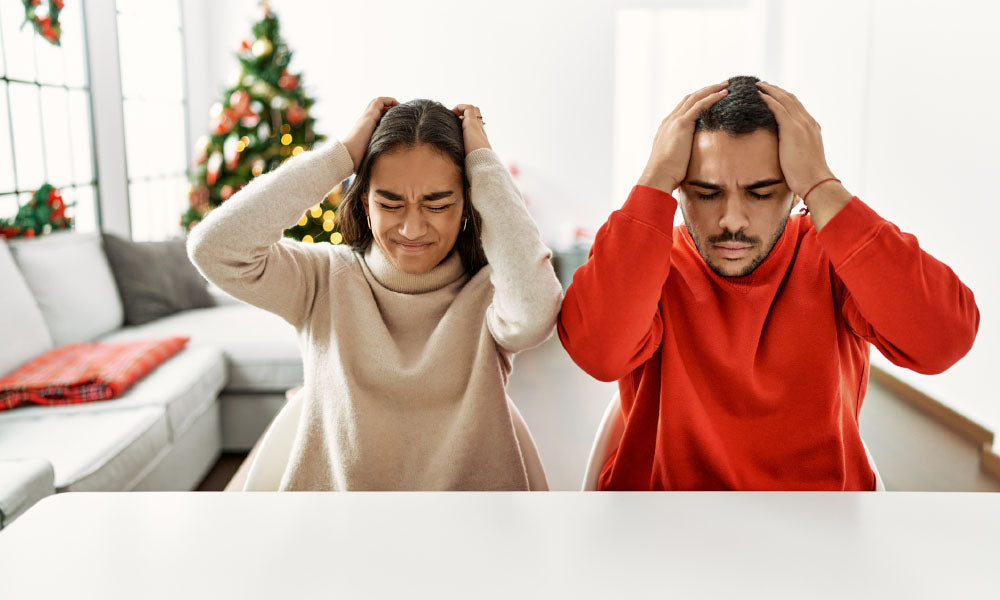 couple sitting on the table by christmas tree