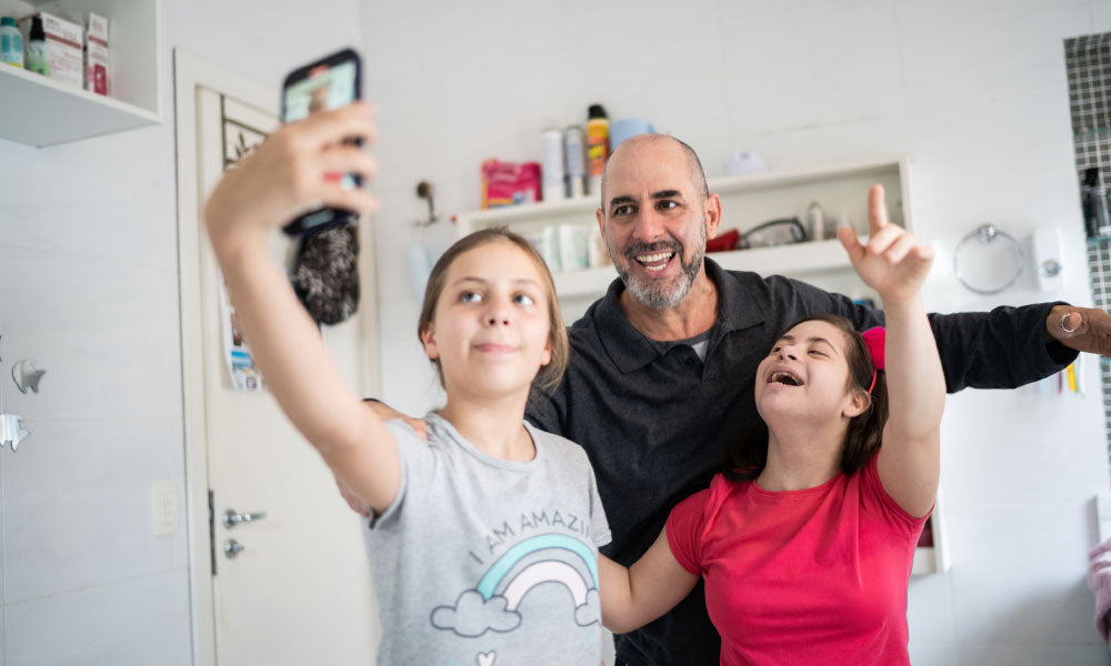 dad with kids taking a selfie