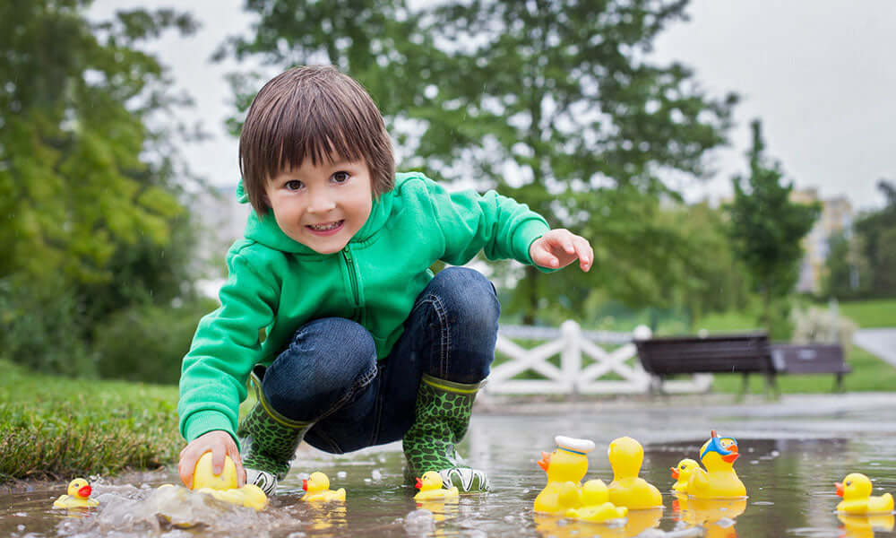 boy playing in a puddle