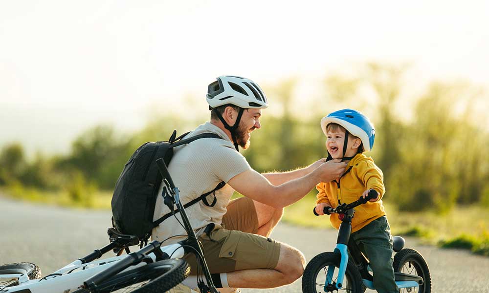 father and son on bikes