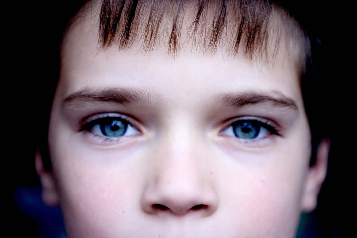 close up of boy with blue eyes