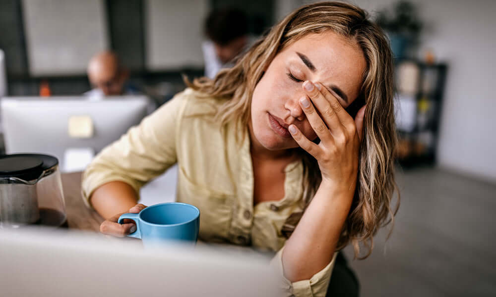 business woman rubbing eyes