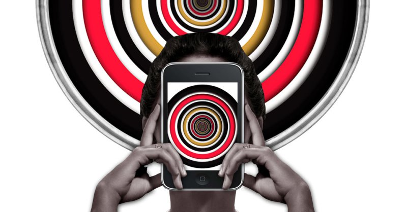 person holding a phone with black red white yellow circles behind