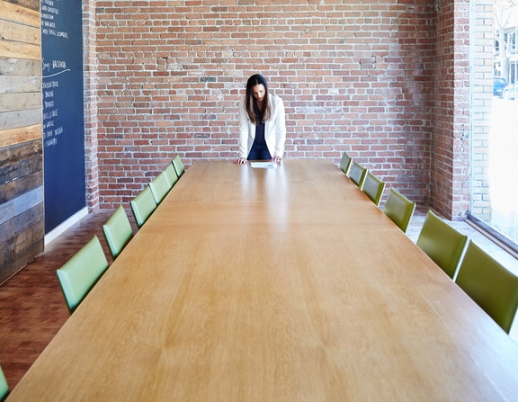 woman leaning on boardroom table