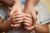 boy holding parents' hands