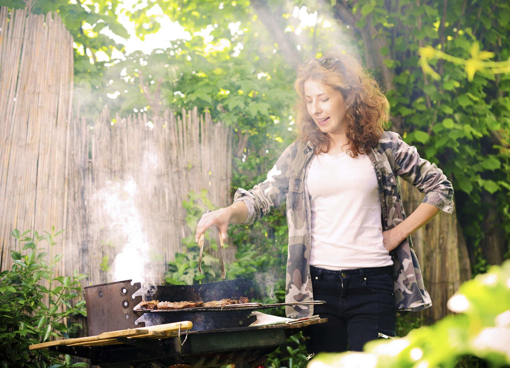 woman cooking on a barbeque in the garden