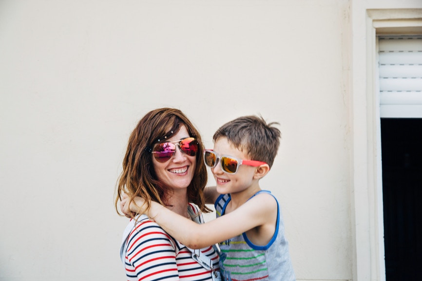 Mother and son wearing matching sunglasses