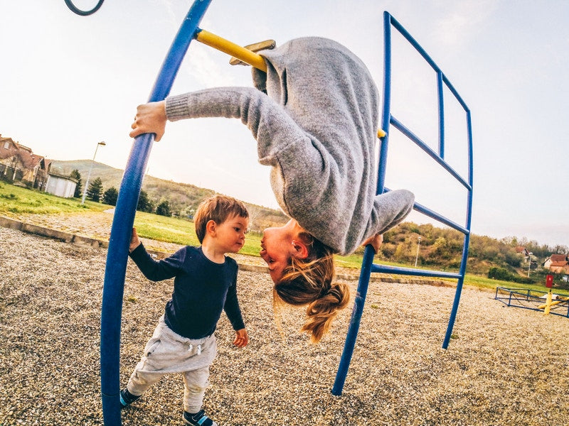 little boy on playground with his mother
