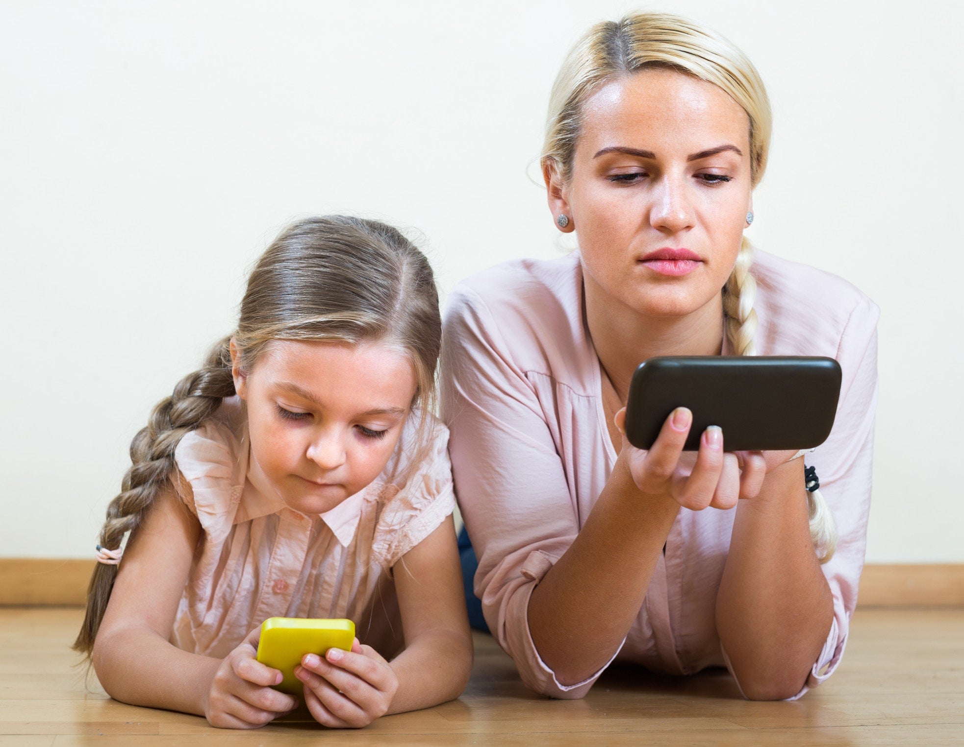 Mother and daughter using cellphones