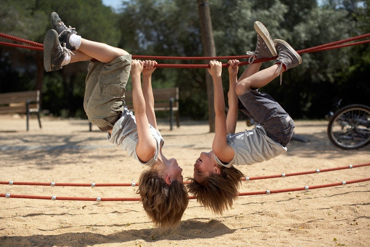 Two children playing on a rope