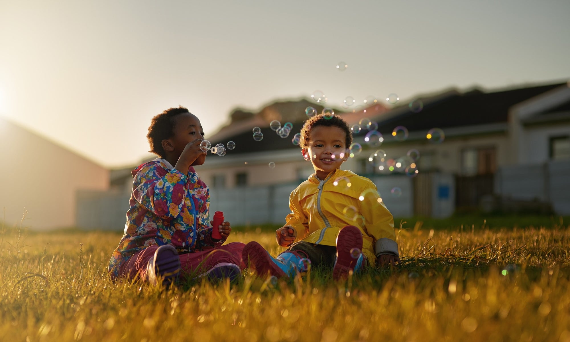 two kids playing soap bubble