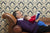 grandfather reading book for newborn grandson on  a sofa