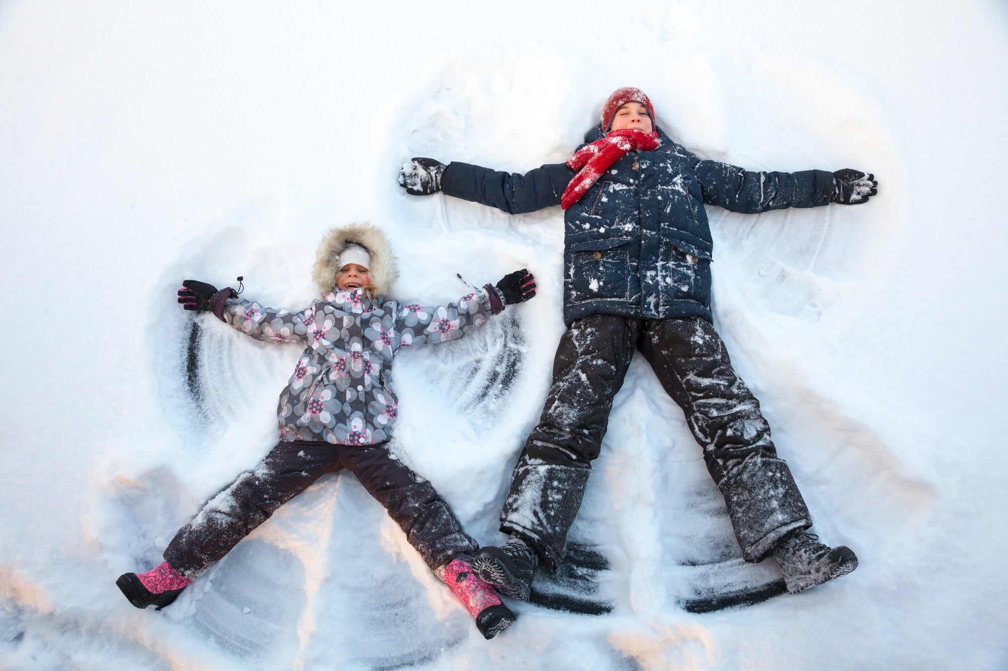Two children playing in snow