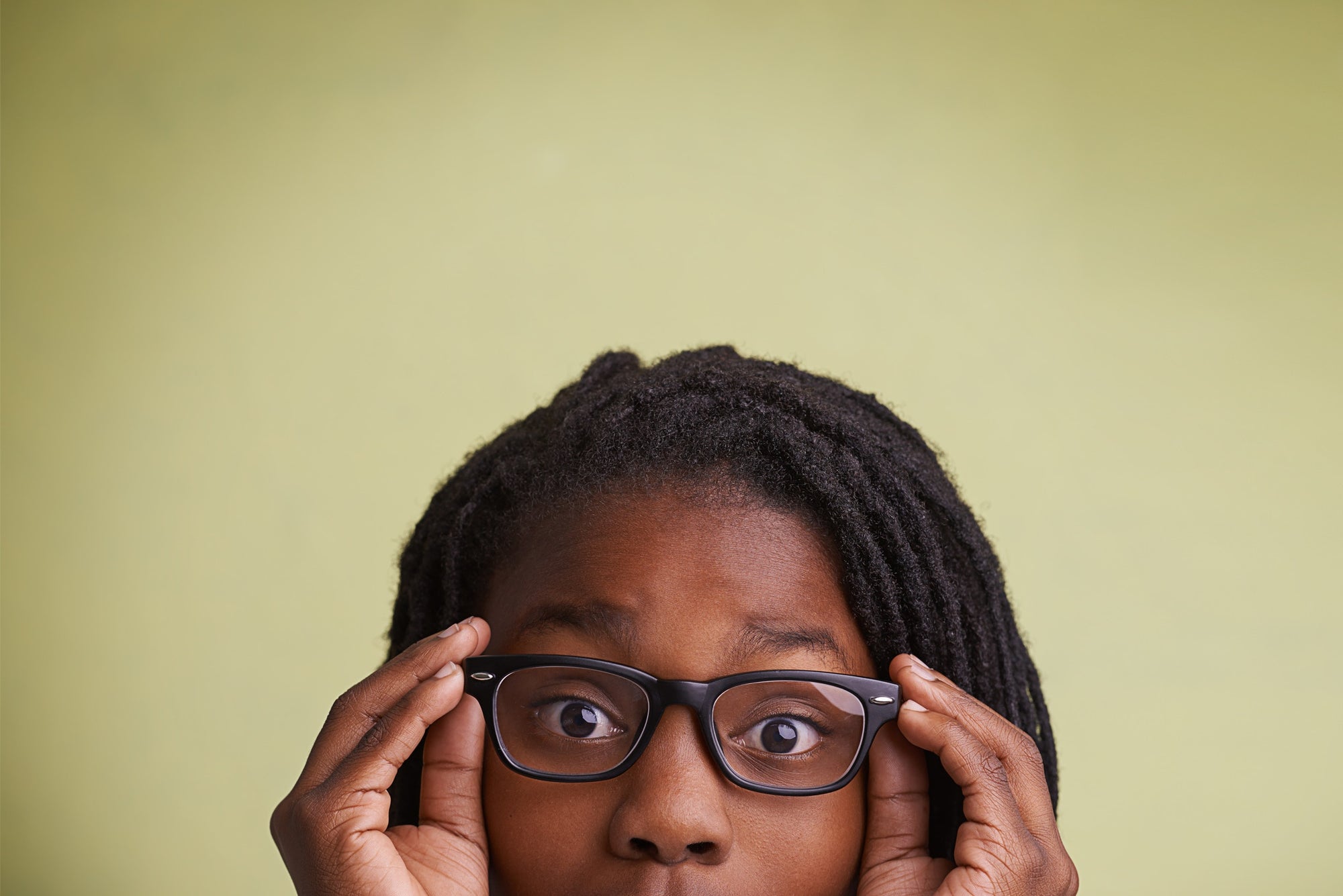 young girl holding her spectacles