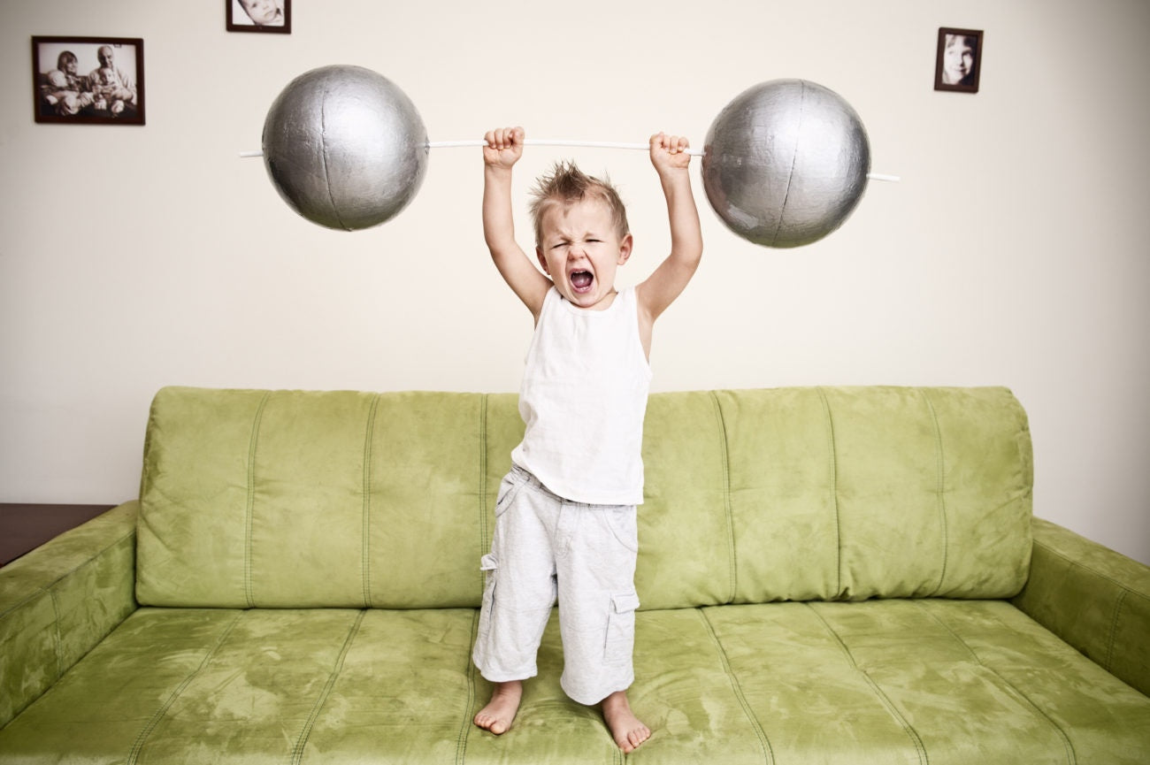 young boy lifting weight