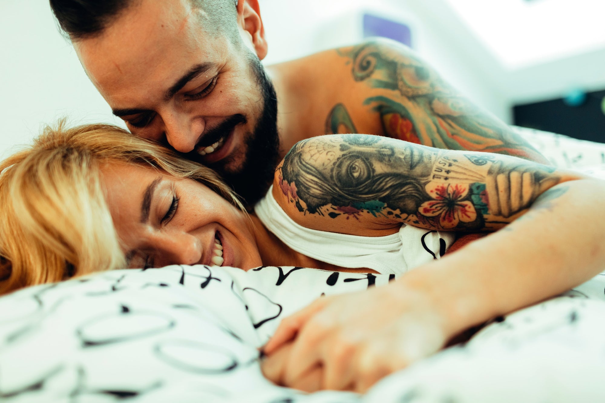 man and woman with tattoos