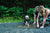 parents with cute little baby playing in mud