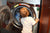 little boy putting clothes in washing machine